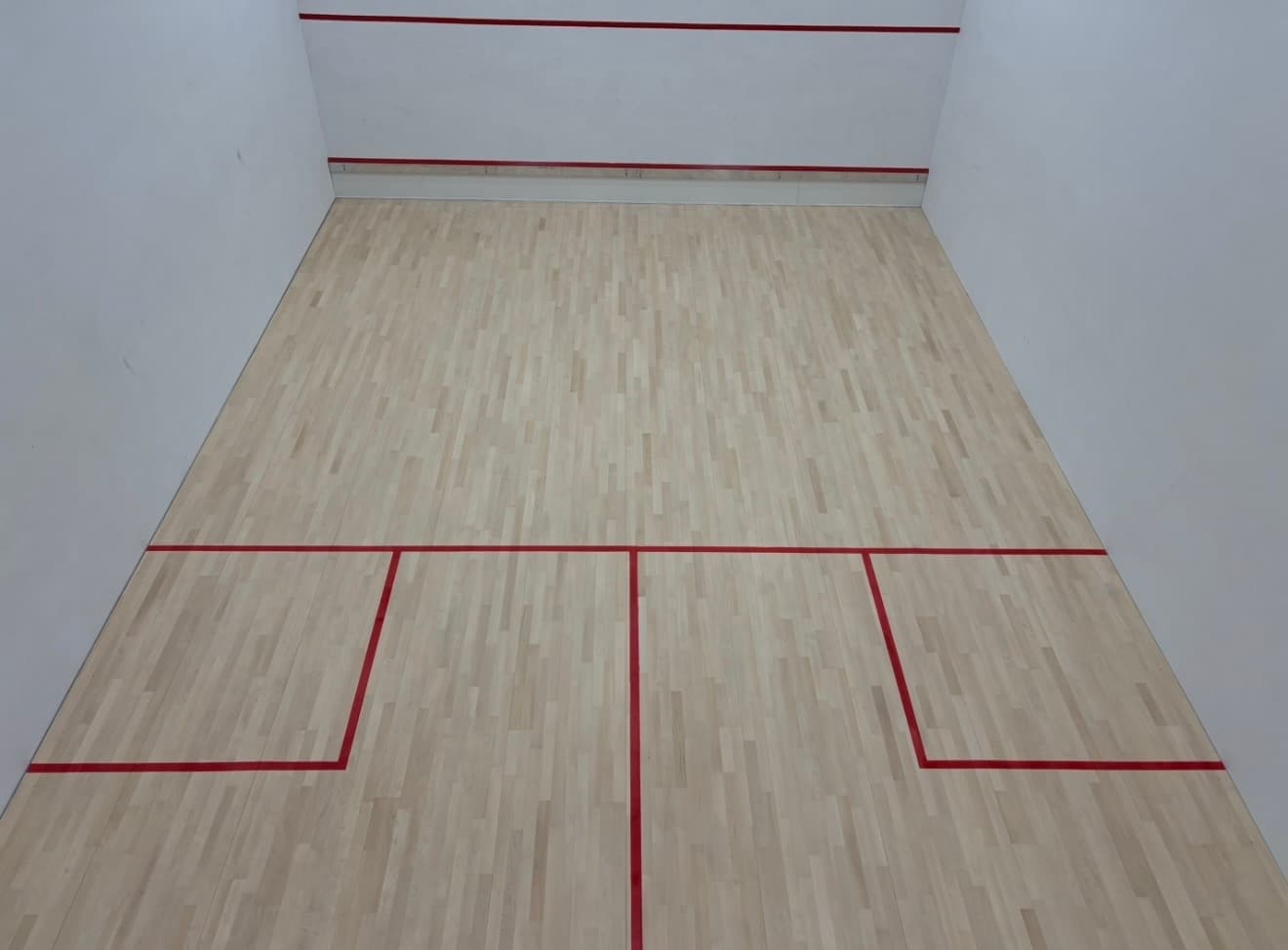 A restored squash court floor, sanded and sealed