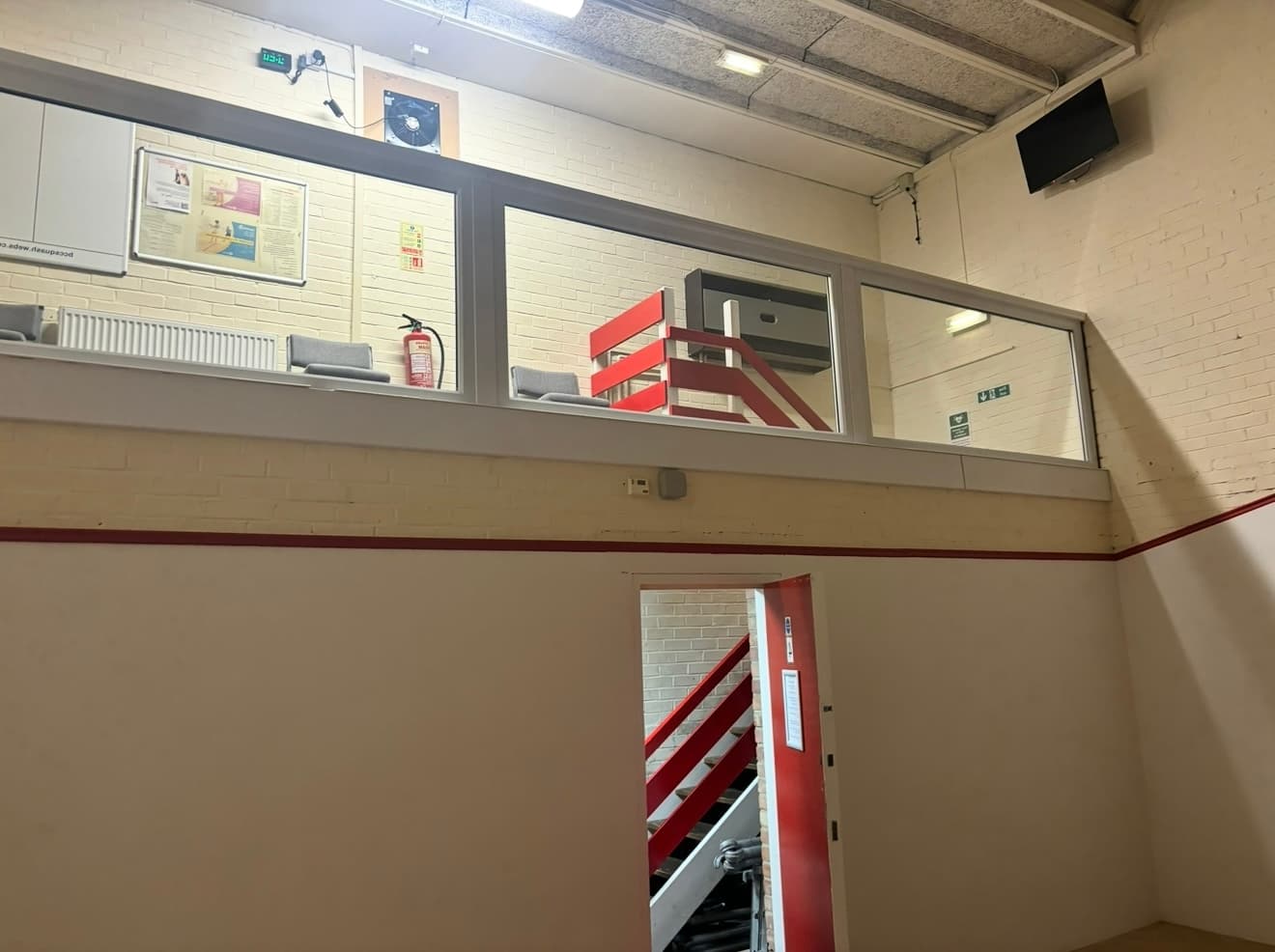 Solid squash court back wall before the glass installation