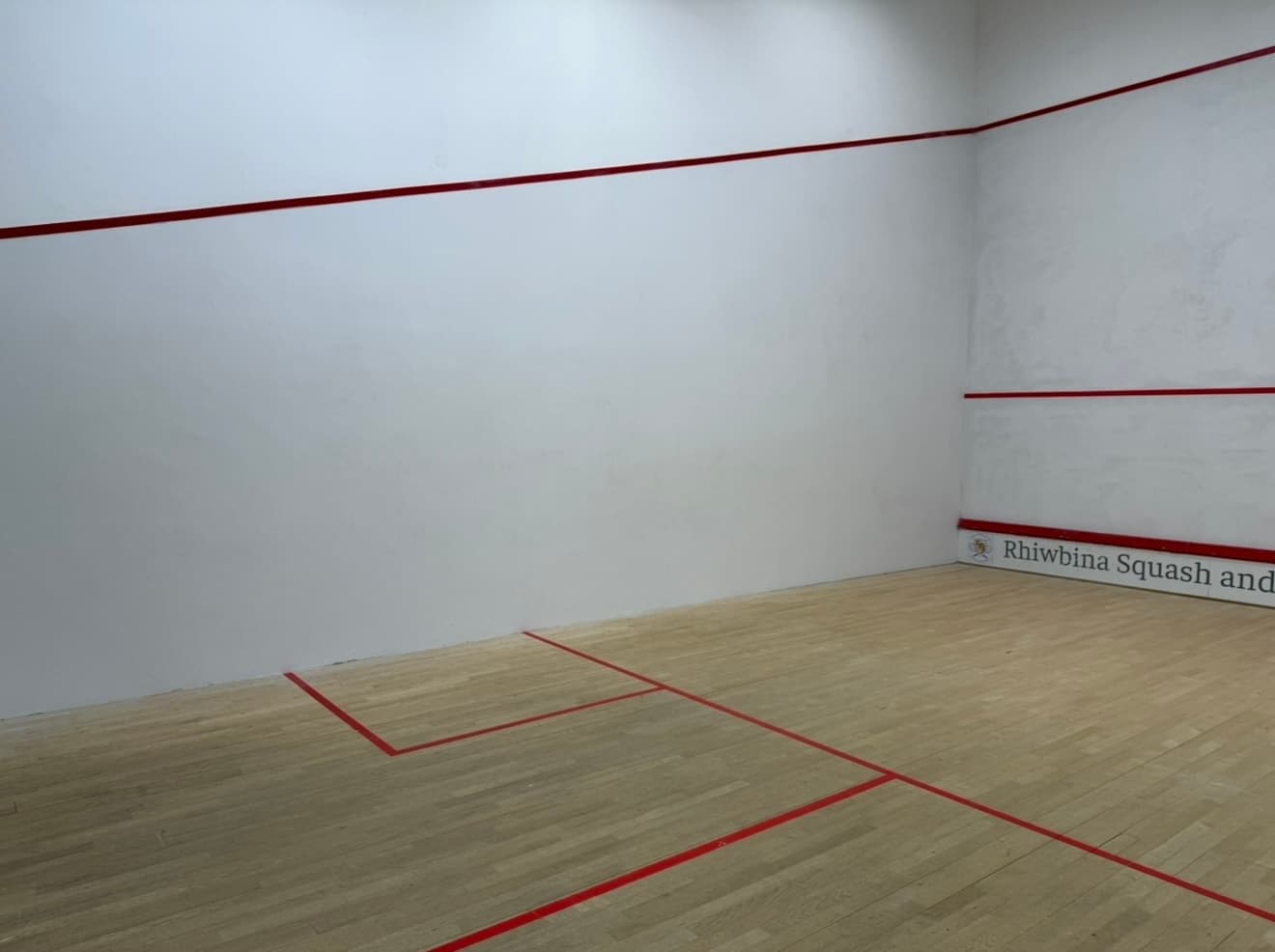 Squash court side wall finished in clean, even white
