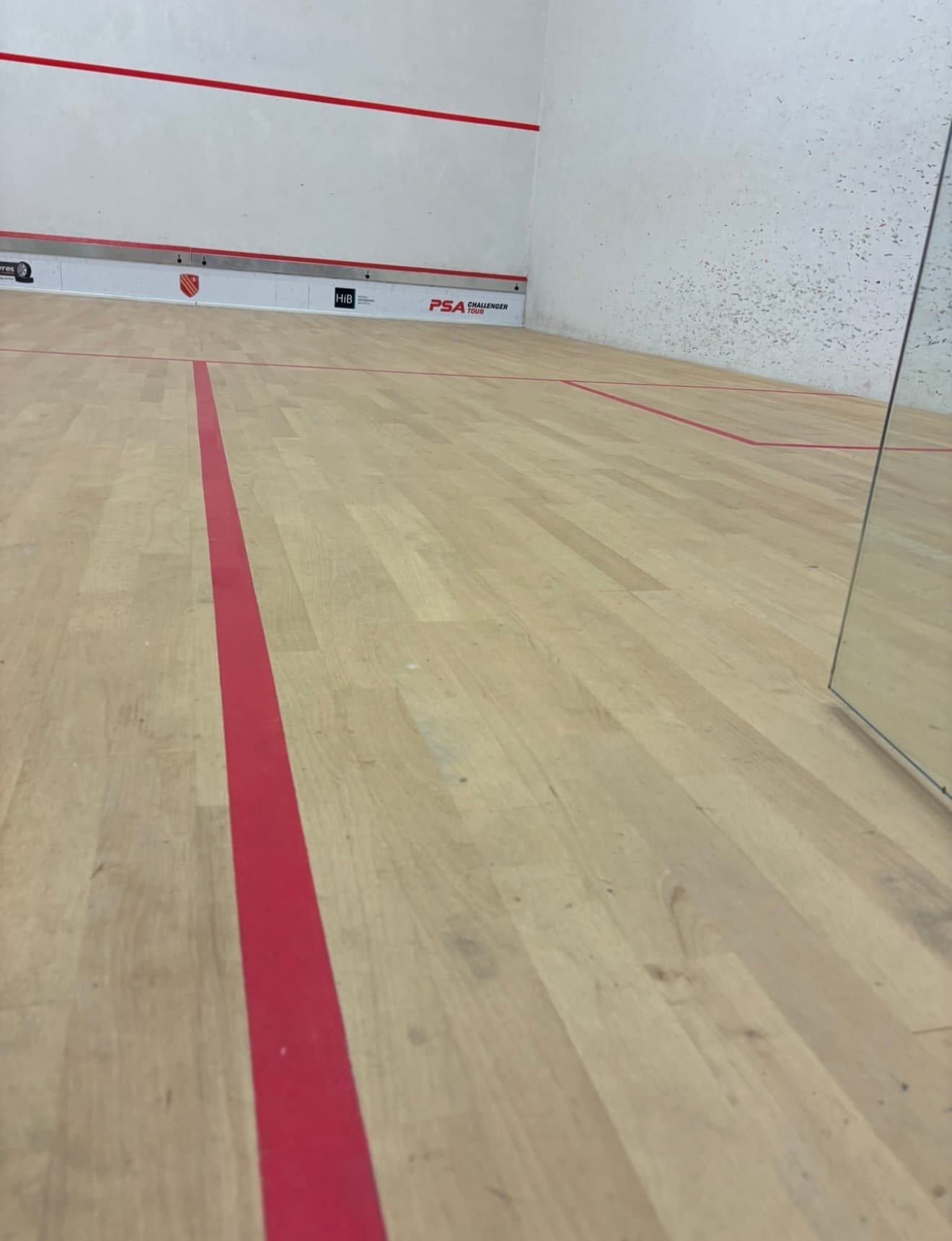 Repaired squash court floor with new boards sanded flush