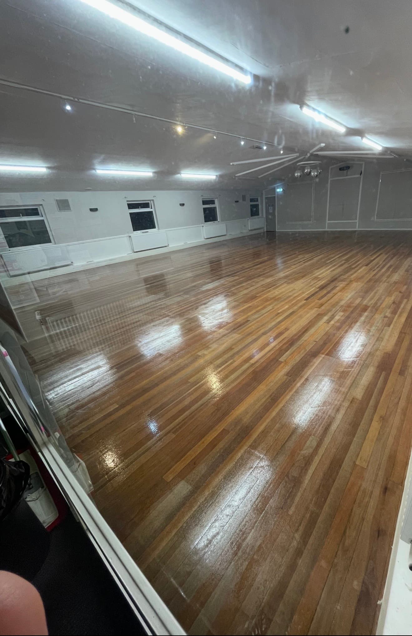 Squash court floor sanded back to clean timber and sealed