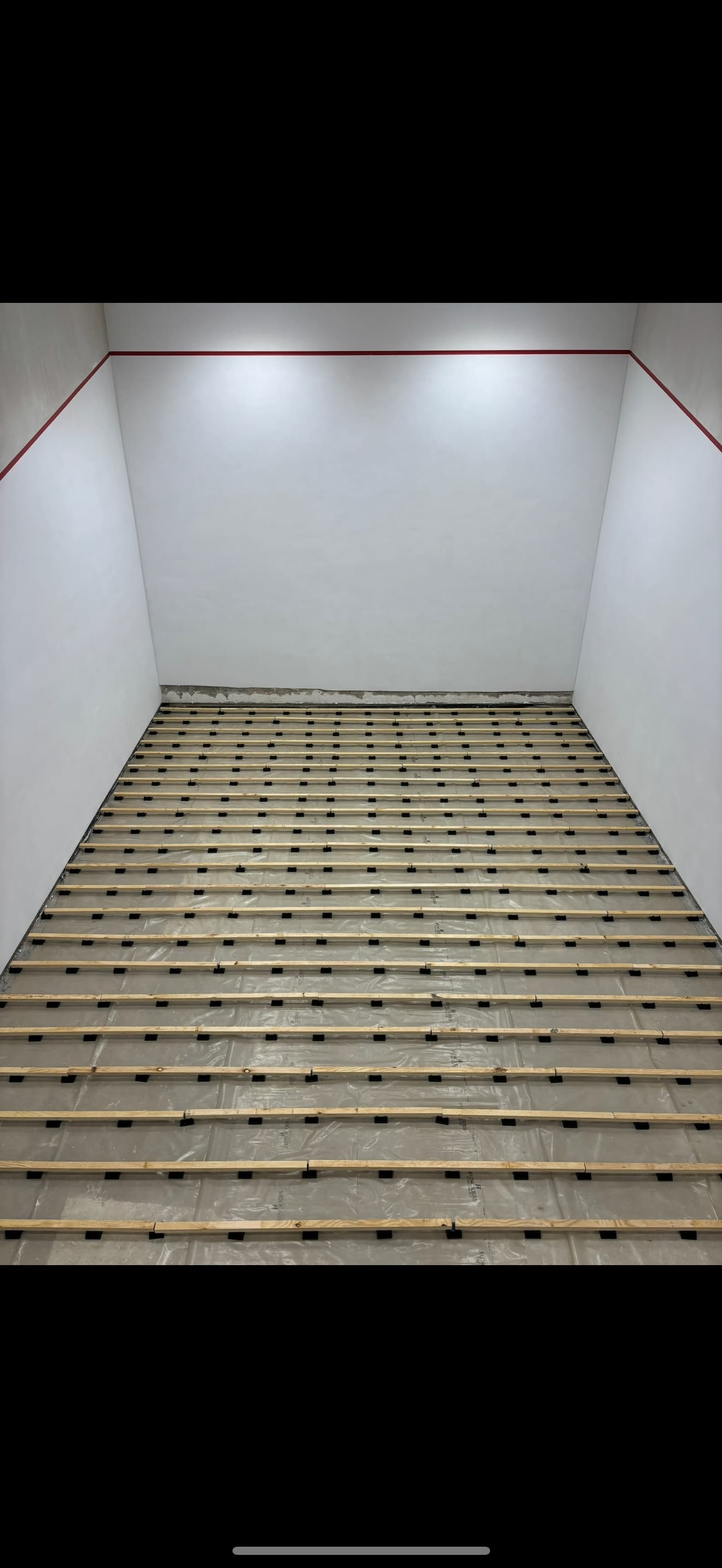 Worn squash court floor before restoration